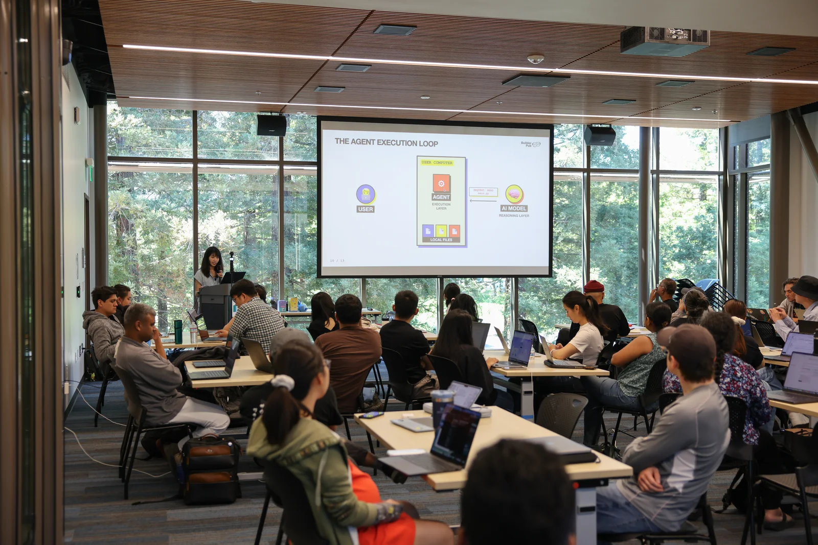 A Builder Pub AI workshop with participants working on laptops